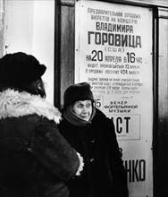 Two russian women in front of a poster advertising vladimir horowitz's concert in moscow, april 1986.