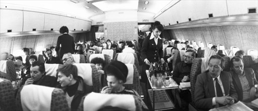 Passengers being served abord an aeroflot il-86 airliner on a newly inaugurated route between moscow and rostov-on-don, january 1983.