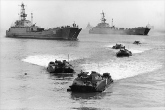 Soviet military exercises, pt-76 amphibious tanks disembarking from aboard landing ships, october 1988.