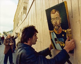 Artist stanislav kapilov putting up a portrait of tsar (czar) nicholas ll on the arbat - an act that would have been politically risky before the glasnost era, september 1988.