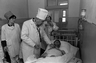 Khushkadam kamardinov, chief infectionist of tajikistan, is pictured during medical examination of one of the typhiod patients at an intensive therapy unit of a dushanbe's hospital on feb, 26th, typho...