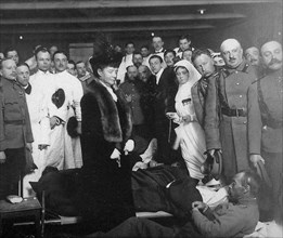 The photo 'empress maria fyodorovna presents the russian red cross society's decoration to a wounded soldier' (1916) is on view at the exhibition 'empress maria fyodorovna, the return' in the state ce...