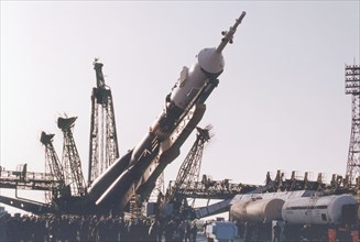 Baikonur, kazakhstan , april 26, 2001, a souyz tm-32 spacecraft with a booster-rocket pictured being erected at a launching site of baikonur cosmodrome on thursday , the launch of a russian crew and t...