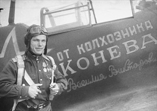 Great patriotic war, the second ukrainian front, hero of the soviet union ivan kozhedub is standing near the aircraft constructed on the money of vasily konev.