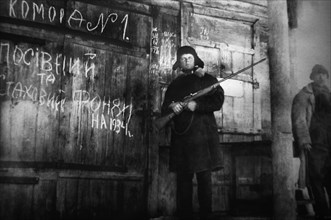 An armed man guards the storage of crop and emergency supply grain for the year 1934 in this documentary photograph displayed at an exhibition in kiev, dedicated to holodomor, the great ukrainian fami...