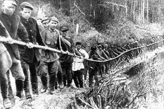 Victims of political repressions, sent to prisons and concentration camps of the ukhta expedition of the north camp's administration are pictured working on the izhma river in 1929.