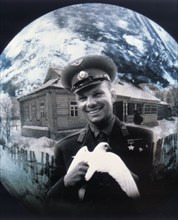 Cosmonaut yuri gagarin holding a white dove.
