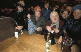 A crowd of people buying vodka in moscow, russia duing times of shortages, march 1991.