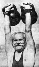 62 year old engineer from joshkar-ola, g,s, komissarov lifting two 32kg weights, reproduced from the newspaper 'sovietskaya industria'.