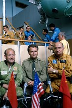 1975, soyuz-apollo mission, head of soyuz crew alexei leonov (left), shatalov, thomas stafford (apollo team leader) at soviet training center.