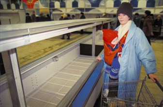 A mother with her child shopping in a moscow supermarket during the times of economic reforms which brought about shortages and rising prices, 1991.