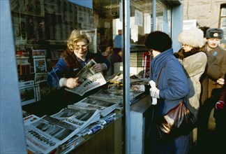 Moscow citizens buying newspapers at a kiosk, 1986s.