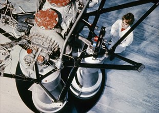 Soviet technician inspecting part of an  rd-? rocket engine installed in the second stage of cosmos carrier rockets, 1969.
