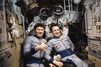 Soviet cosmonauts valery ryumin (left) and leonid popov, crew of the soyuz 35 mission, aboard the salyut 6 space station, april 1980.