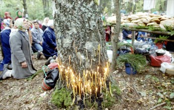 The republic of mari el (russian federation), pagans pray in the sacred kupriyanovskaya grove during a pagan holiday before sharing a common meal of boiled meat and bread, 11/95 .