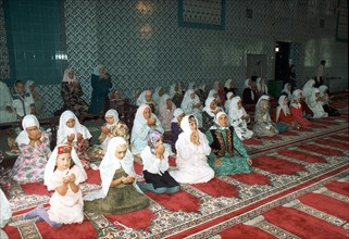 Almetyvsk, tatarstan, russia: women praying in moslem center built partly with funding from tatneft oil company.