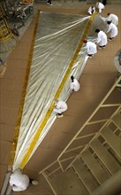 Specialists of lavochkin scientific production association are packing a part of sunlight-propelled solar sail spacecraft while preparing it for the launch, moscow region, russia, april 7, 2004.