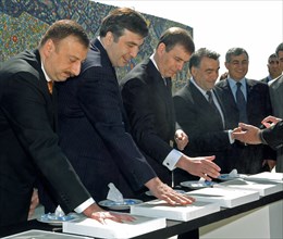 Azerbaijan, may 25, 2005, azerbaijani president ilham aliev, georgian president mikhail saakashvili and representatives of international organizations make hand prints on plaster bricks during an inau...