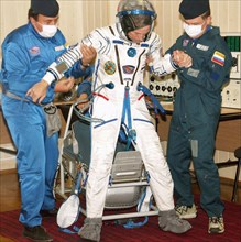 Baikonur, kazakhstan, september 23, 2005, crew member of the 12th mission to the international space station, space tourist gregory olsen gets used to his in-flight space suit.