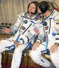 Baikonur, kazakhstan, october 1, 2005, space tourist american gregory olsen and russian flight engineer valery tokarev (from left) prior to the launching of the soyuz tma-7 spacecraft which deliver th...