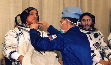 Baikonur, kazakhstan, april 18, 2001, first space tourist, dennis tito (l) and russian cosmonaut talgat musabayev (r) trying on their spacesuits in preparation for the flight to the iss, scheduled for...