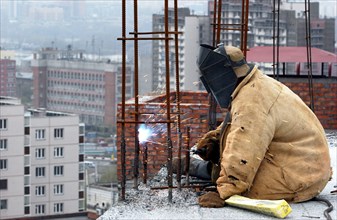 A worker welding on the construction site of a new housing complex in novosibirsk, russia, april 2007.