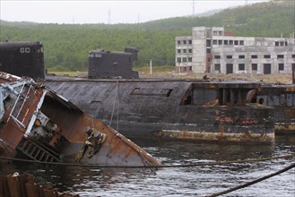 Murmansk region,russia, august 29, 2001, rusty hulls of russian decommissioned submarines pictured being scrapped at belokamenka settlement at kola peninsula (northern russia).