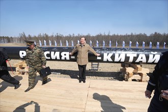 Amur region, russia, april 27, 2009, chinese official posing near a branch pipeline which will run into china from the eastern siberia – pacific ocean (espo) oil pipeline, the slogan on the pipeline r...