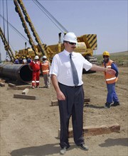 Azerbaijan, august 11, 2003, head of azerbaijan government ilkham aliyev (c) pictured visiting the construction site of the baku-ceyhan oil pipe line,on monday.