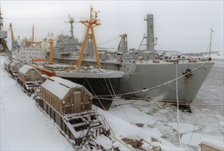 Radioactive waste from nuclear-powered submarines unloaded from a ship onto a special train for transportation to reprocessing mills in the urals, murmansk, russia,  2000.