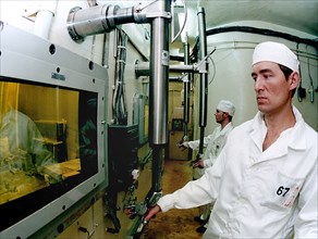 Ulyanovsk region, russia, december 2 2002: operator alexander glotov, of the all-russian institute of atomic reactors (nllar), controls a chamber for production of springs, filled with cerium-144, the...