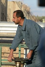 Baghdad, iraq, february 8 2003, worker (in pic) at one of large oil refineries on the outskirts of baghdad.