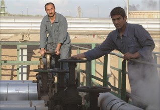 Baghdad, iraq 2/03: workers at oil refinery on the outskirts of the city.