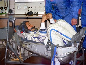 Kazakhstan, april 11, 2003, the flight engineer of the soyuztma-2 spacecraft edvard lu (c) is trying on his space suit during preparation for the flight at cosmodrome baikonur, the spaceship soyuztma-...