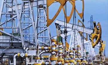 Oil derricks (jack pumps), oil extraction at an oil-field of yukos oil company, tomsk region, siberia, russia, january 19, 2004.