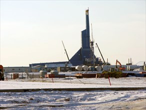 Facilities for developing the chaivo (chayvo) field, with the yastreb (‘hawk’) rig shown in the center, a 221--km-long pipeline
