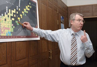 Deputy director of the flerov laboratory of nuclear reactions, professor, sergei dmitriyev pointing to a chart as he explaines to reporters how a recent research was carried out at the flerov laborato...