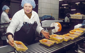 A woman working on an assembly line at the petelino poultry factory which produces 1,000 tons of broiler meat per month, moscow region, russia, march 2002.