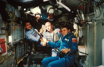 Soviet cosmonaut svetlana savitskaya (soyuz t-7) aboard the salyut 7 space station with the soyuz t-5 crew: anatoly berezevoi and valentin lebedev, first coed space crew, august 1982.