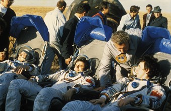 Soyuz t-10 crew leonid kizim, oleg atkov, and vladimir solovyov return after 237 days in space aboard the salyut 7 space station, 1984.