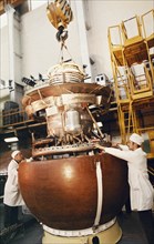 The descent module venera being assembled at the baikonur cosmodrome in preparation for the vega 1 & 2 space projects to be launched on december 15 & 21, 1984.