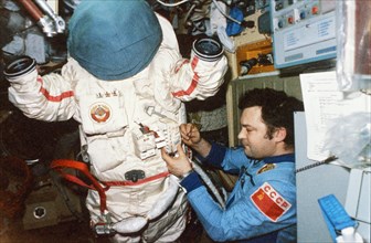 Soyuz tm-2, soviet cosmonaut yuri romanenko aboard the mir space station getting ready for a spacewalk (eva), 1987.