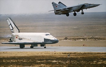 Soviet space shuttle buran landing at the yubileiniy airfeild at baikonur in kazakhstan, ussr after an unmanned test flight, 1988.