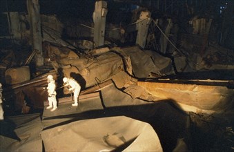 Men inspecting the inside of the sarcophagus containing the unit 4 reactor of the chernobyl aps, ukraine, ussr, march 1991.