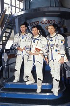 Soyuz tm-17, aleksandr serebrov, vasily tsibliyev, and jean-pierre haignere in front of a soyuz simulator during training, 1993.
