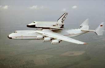 The antonov-225 mriya super-heavy transport aircraft conducting its first flight carrying the soviet space shuttle, buran, may 1989.