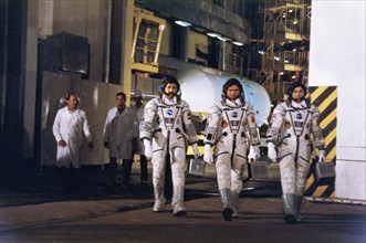 Soyuz tm-3 crew muhammed faris (syria), alexander viktorenko, and aleksandr pavlovich aleksandrov prior to launch, july 1987.