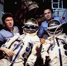 Salyut 6, soyuz 35 crew valery ryumin and leonid popov moving space suits from soyuz 35 to soyuz 36, 1980.