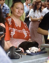 Woman selling puppies at a pet market in moscow, 1989.