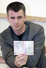Krasnoyarsk territory, russia, july 20, 2009, mikhail prokhorov, polyus gold (polyus zoloto) chairman, and onexim (oneksim) group president, displays his passport to confirm that he now has the offici...